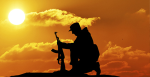 image of solider silhouette kneeling with gun